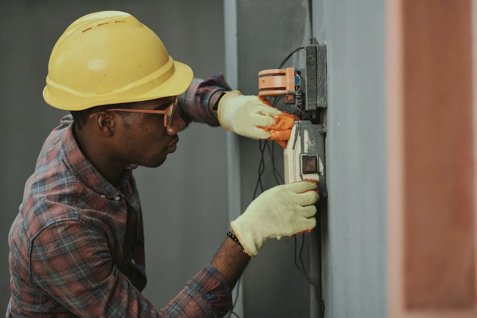 Electrician working on an open switchboard